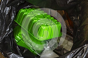 Plastic containers in a trash bag