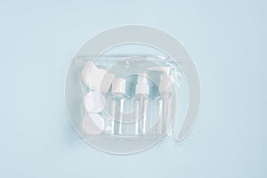 Plastic containers. Travel set on a blue background.
