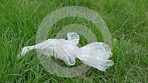 Plastic contaminate the earth. Ripped polyethilene fluttering on grass