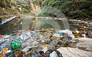 Plastic Contamination into Nature. Garbage and bottles floating on water.