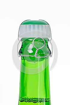 Plastic cork with wire on sparkling wine bottle