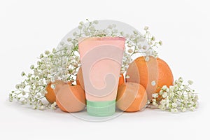 Plastic cosmetic tube on white background with flowers and fruits, mockup. Skin care cream with citrus extract, collagen, vitamin