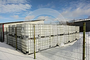plastic cubic water container protected by a metal grid