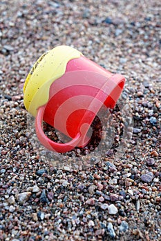 Plastic cup on sand photo