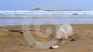 plastic cup thrown like garbage on the sand of the Enseda beach