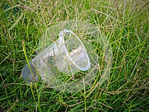 Plastic cup trash on the grass. photo
