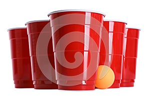 Plastic cups and ball for beer pong on white background