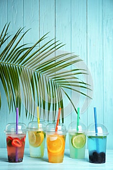 Plastic cups with lemonades on table