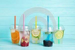 Plastic cups with lemonades on table