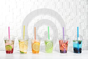 Plastic cups with lemonades on table