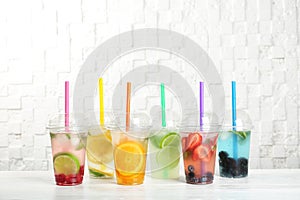 Plastic cups with lemonades on table