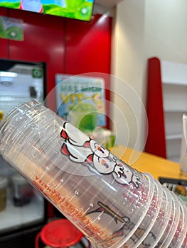 plastic cups stacked with white pictures in a drinking place