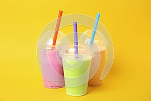 Plastic cups of tasty milk shakes photo