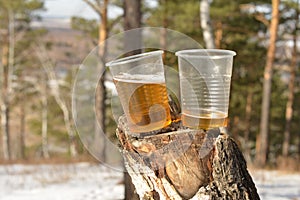 Plastic cups on tree stump