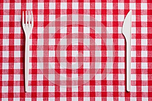 Plastic cutlery on checkered tablecloth