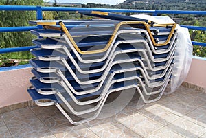 Plastic deckchairs. stacks of sunbeds