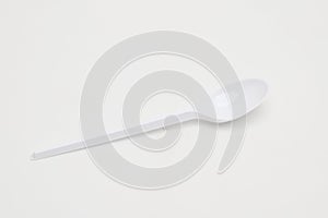 Plastic disposable spoon on a white background.