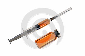 Plastic disposable syringe with medicine and a glass bubble with