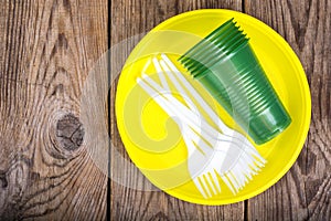 Plastic disposable tableware on wooden table