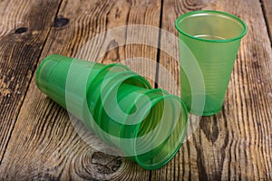 Plastic disposable tableware on wooden table