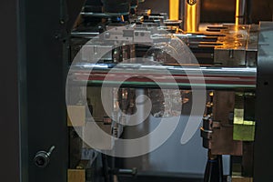 The plastic drinking bottles in the  blowing mold machine.