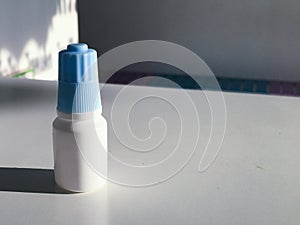 Plastic drop bottle on blur background with copy space