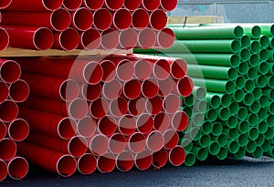 Plastic ducts stacked for underground cables at construction site