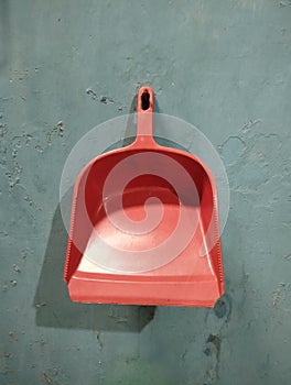 Plastic dustpan garbage isolated on green background