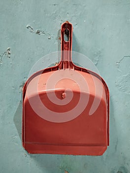 Plastic dustpan garbage isolated on green background