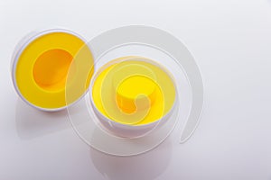 Plastic egg developmental puzzle yellow to form a circle on a white background.