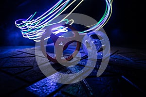 Plastic empty bobbin on dark toned background with light. Music concept