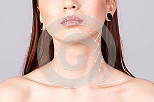 Plastic Facial Surgery beautiful young woman face with arrows on lips.