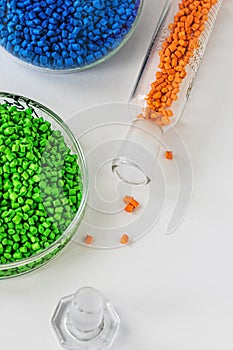 Plastic factory laboratory. Glass flasks with colored dye in granules for plastics. polymer industry