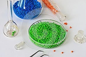 Plastic factory laboratory. Glass flasks with colored dye in granules for plastics. polymer industry