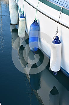 Plastic fenders along white hull