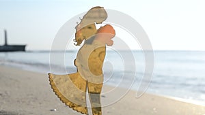 Plastic figure stick young people love girl guy hugging sand beach of sea coast