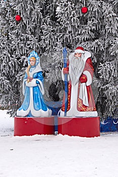 Plastic figures of Santa Claus and snow Maiden on the square decoration for Christmas at the Christmas tree