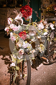 Plastic flower decoration on a vintage bicycle