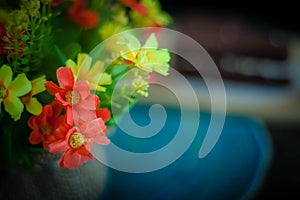 The plastic flowers on a beautiful green and yellow tone color, Blurred gentle sunlight without the sky background. Floral in