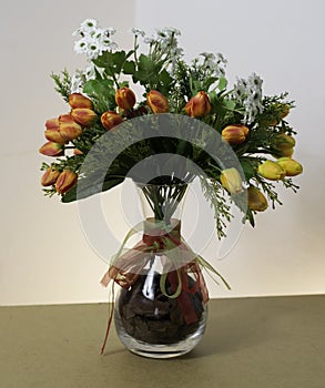 Plastic flowers in a glass pot