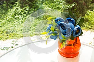 Plastic flowers in vase.