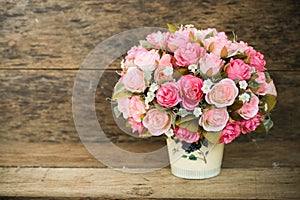 Plastic flowers with wooden background in vintage picture style, home interior equipment, Flowers set on wooden background