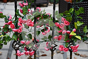 Plastic Flowers Wrapped On Iron Wire Background