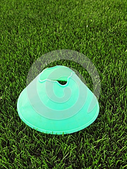 Plastic football green turf playground with grinded black rubber in core and bright green blue plastic cone.