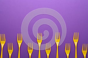 Plastic forks on color background, top view with space for text