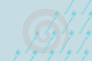 Plastic forks flat lay on blue background