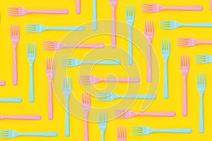 Plastic forks flat lay on yellow background