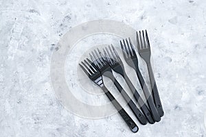 plastic forks on a gray background