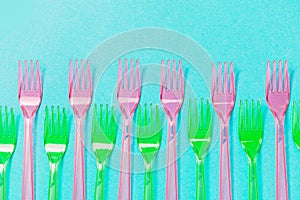 Plastic forks pattern on blue background. Top view, flat lay.