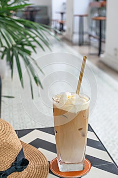Selective focus of iced coffee with reusable metal drinking straw photo